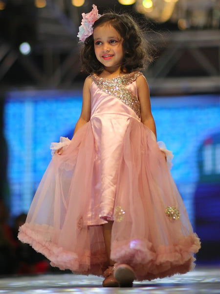 This pink gown comes with a net trail and a back zip closure. It features sequin work on the dress and applique work on trail. Also, it has a fabric belt to be tied at the back.