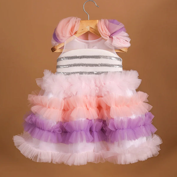 It's a frilly frock with a back zip closure that features sequin lace on the dress with lots of frill detailing.