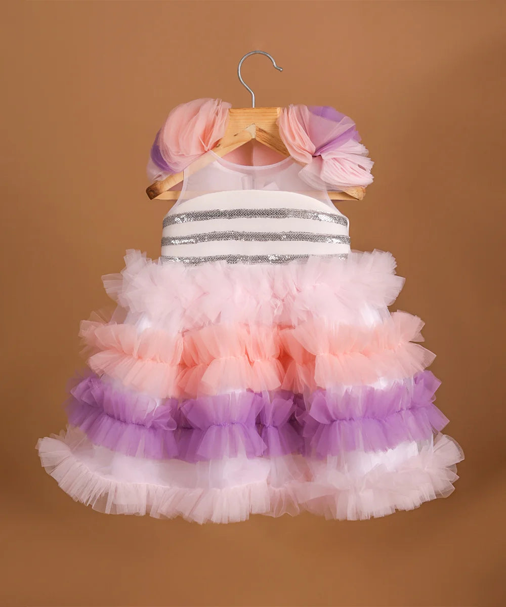 It's a frilly frock with a back zip closure that features sequin lace on the dress with lots of frill detailing.