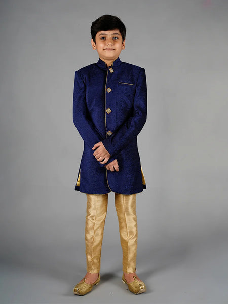 It is a beautiful navy velvet Sherwani paired up with the beige breeches pants. It comes with a stylish buttons on the Sherwani.