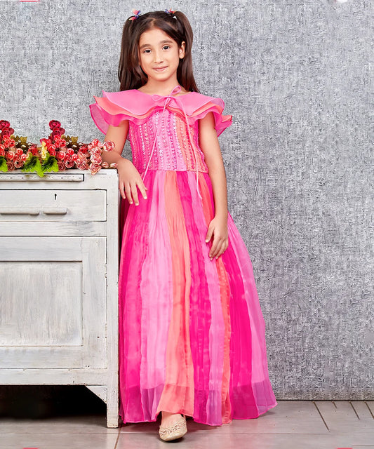 This pink and peach Colored dress consists of a gown and a short triple layer cape. It features floral work on the yoke part of the gown.