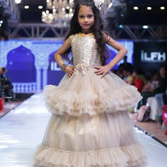 It’s a double layer ruffle girls birthday gown that comes with the back zip closure. Moreover, it is paired up with short sleeves that can be stitched as per requirement. It features floral detailing on the waist and comes with the fabric belt to be tied at the back.