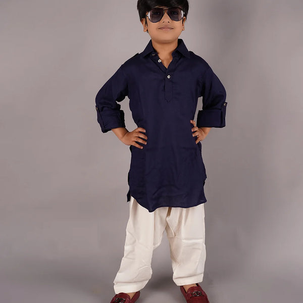 Dress up your kid in this pathani kurta pajama set. It comes with a solid navy colored full sleeves kurta and cream colored Salwar, curated from best quality cotton voile fabric.