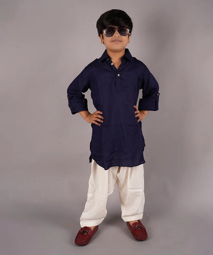 Dress up your kid in this pathani kurta pajama set. It comes with a solid navy colored full sleeves kurta and cream colored Salwar, curated from best quality cotton voile fabric.