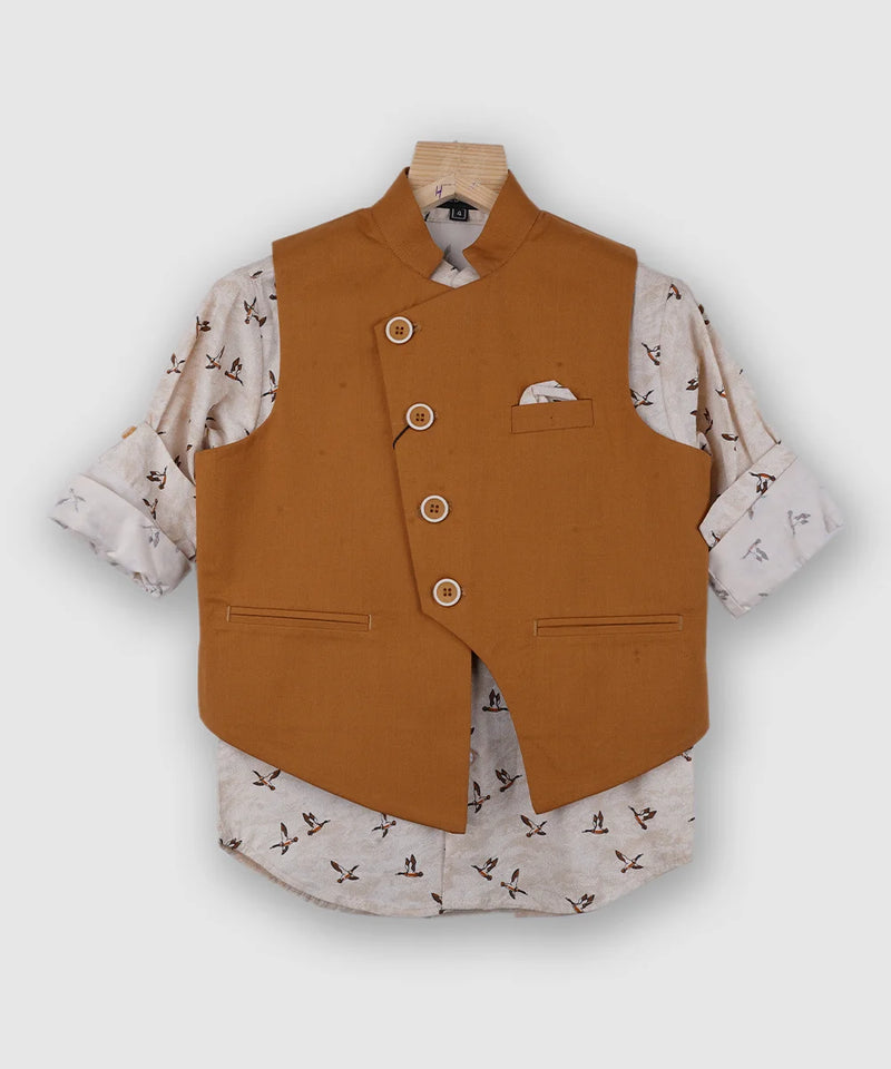 It is a beautiful mustard Color party wear waist coat set for boys. It comes with a printed shirt, a pocket square and a matching mustard Colored pant. 