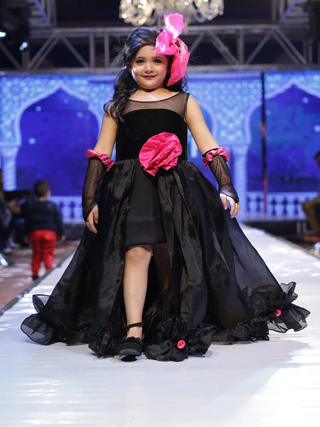 It’s a stylish black gown for girls that comes with the back zip closure. It features big flower on the waist and small floral detailing on the ruffles present at the bottom side of the gown.