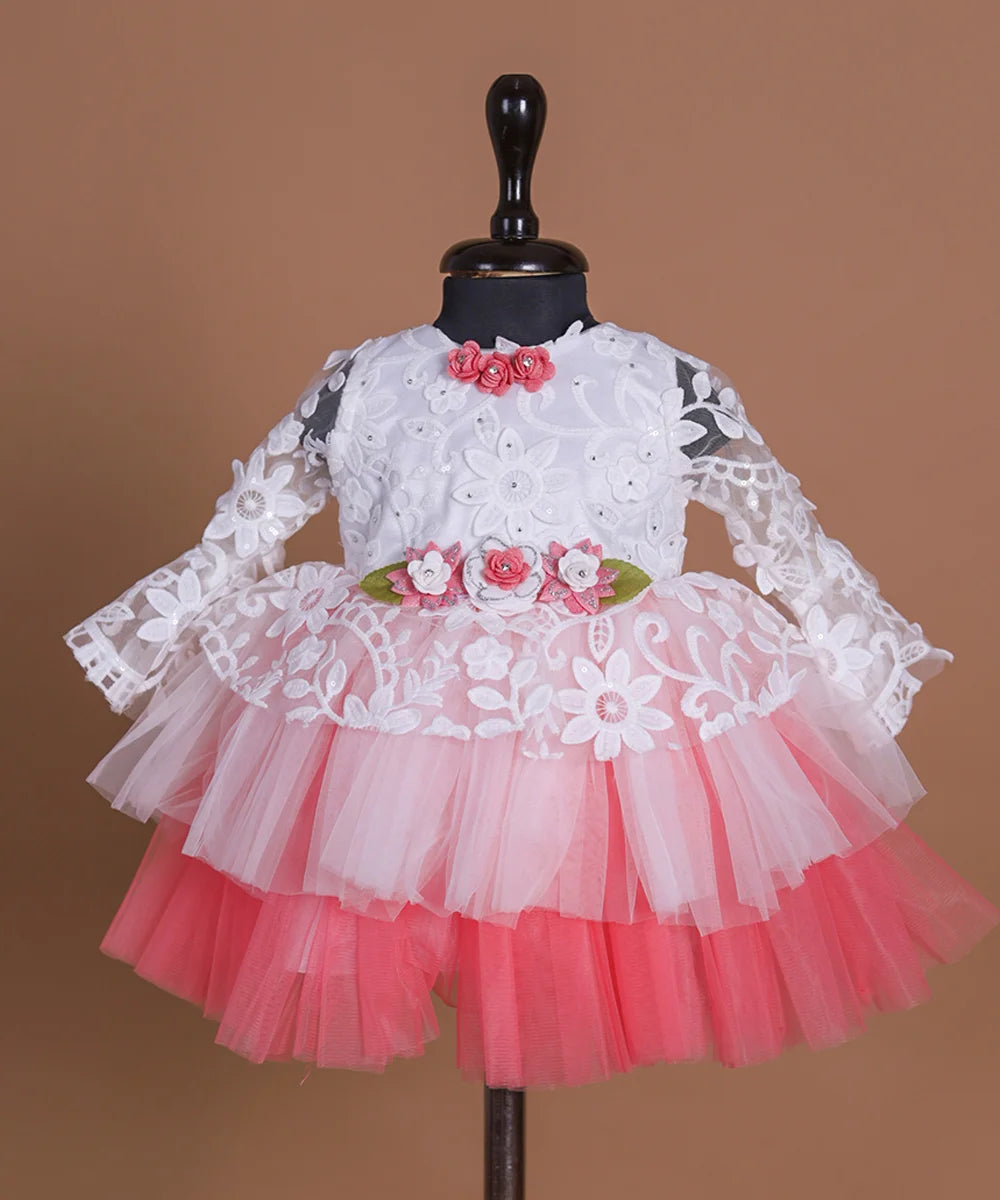Full sleeves laced Birthday frock with floral detailing on the waist and neck.