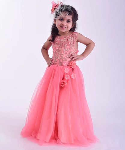 It is a beautiful pink party gown that comes with a back zip closure, and a perfect kids wedding dress. It features floral work and zari embroidery net fabric.