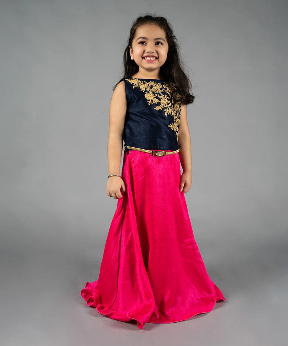  It is a navy blue and neon pink Colored gown paired up with a golden Colored belt and comes with short sleeves that can be stitched as per requirement. It features floral embroidery detailing on the dress that uplifts the entire look.