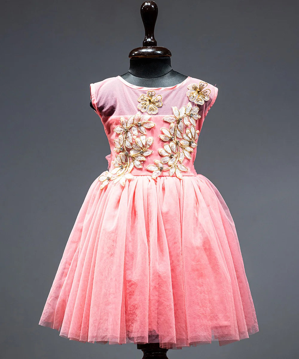 Peach Colored frock that comes with a zip closure at the back and with floral applique work in front.