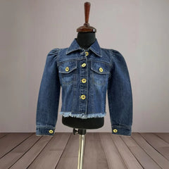 It's a blue denim jacket for baby girls with power shoulder detailing that uplifts the entire look.
