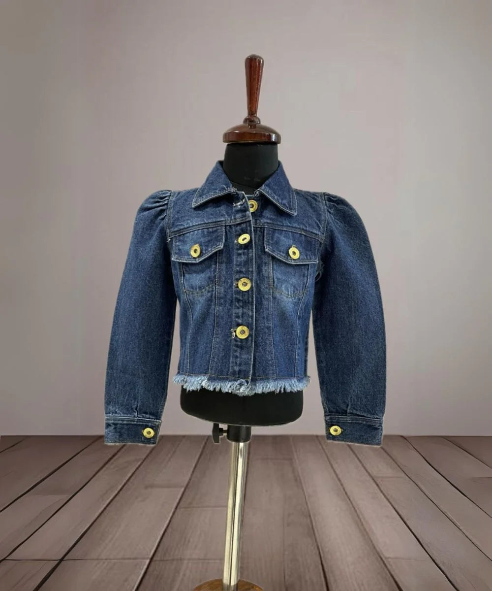It's a blue denim jacket for baby girls with power shoulder detailing that uplifts the entire look.