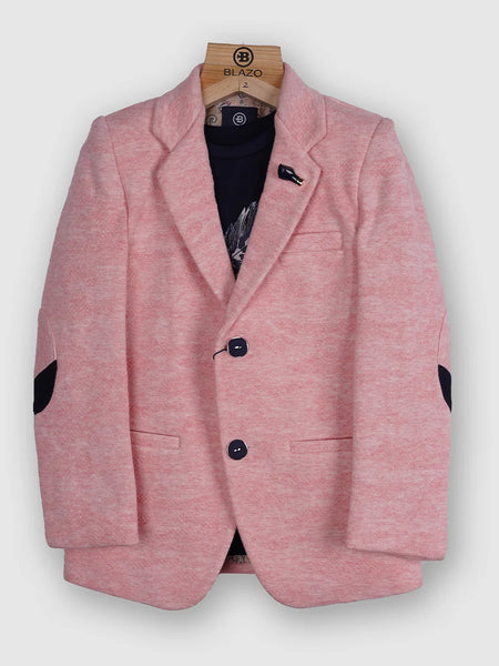 It is a beautiful light pink color, textured blazer that features a cute broach and a patch elbow detailing on the sleeves. It comes with a matching half sleeves round neck blue Colored t-shirt.