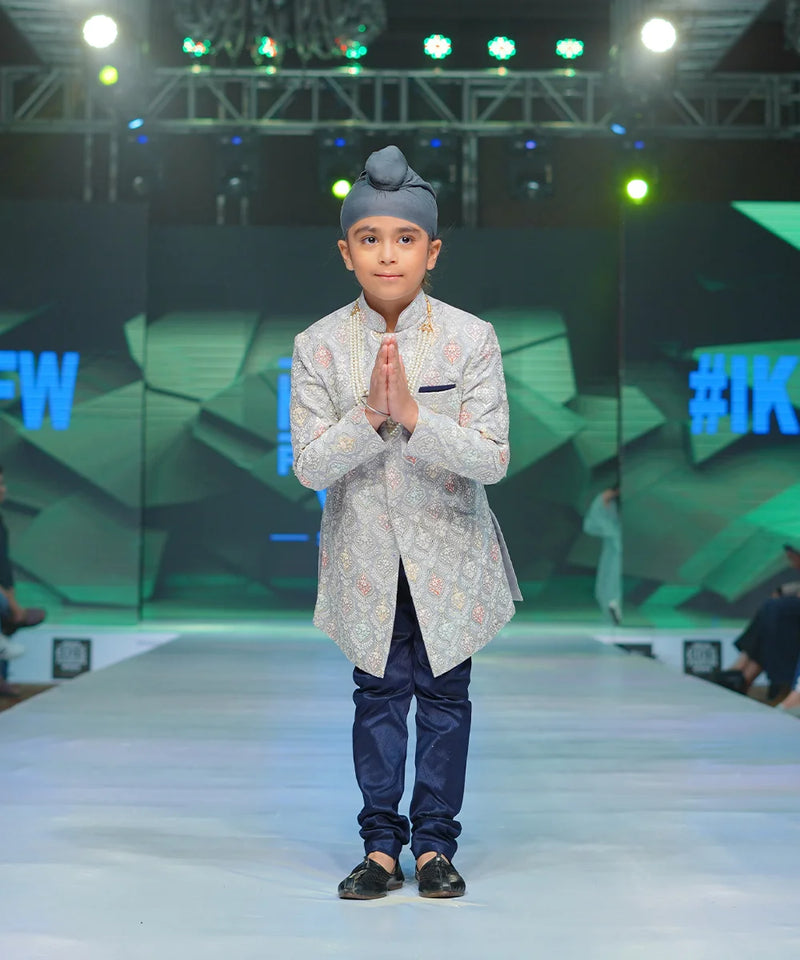 It is a beautiful steel-colour self-embroidery Sherwani for a wedding function for boys paired up with a navy colour Churidar Pyjama.