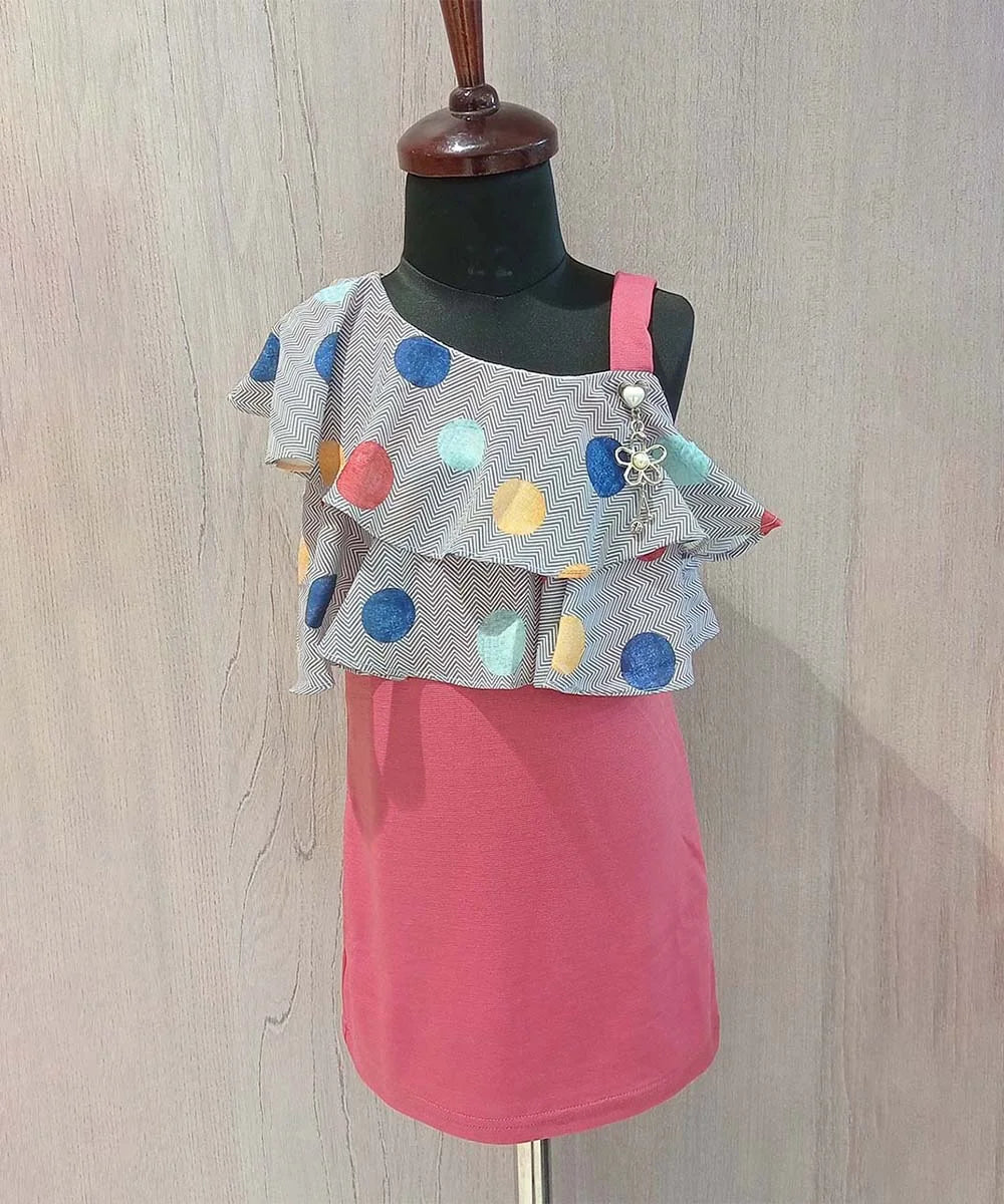 It’s a straight fit pink and grey Colored trendy dresses for kids that comes with a polka-dotted ruffled neck for party looks.  It features a beautiful broach and a back zip closure.