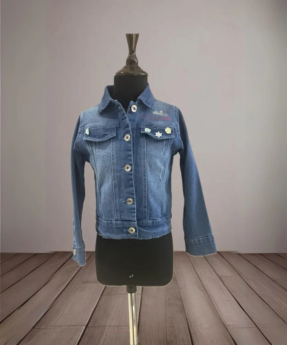 It's a blue denim jacket for kid girls with an inscription and cute small floral detailing that uplifts the entire look.