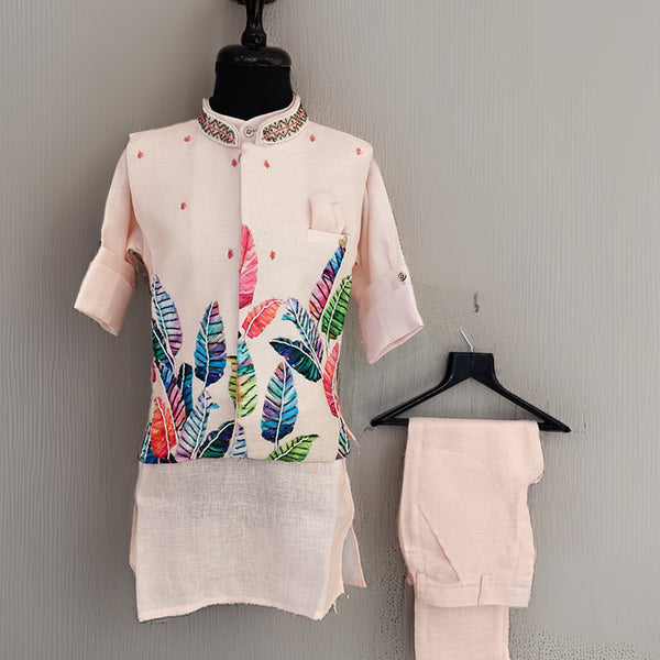 Mannequin wearing a light pink kurta with colorful leaf pattern and matching pants against a gray background.