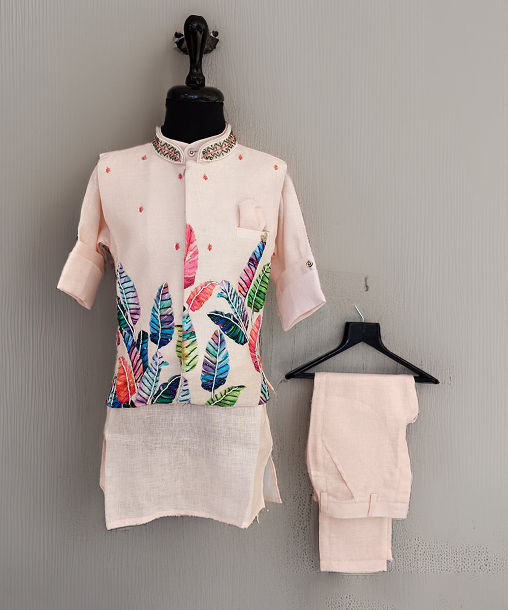 Mannequin wearing a light pink kurta with colorful leaf pattern and matching pants against a gray background.