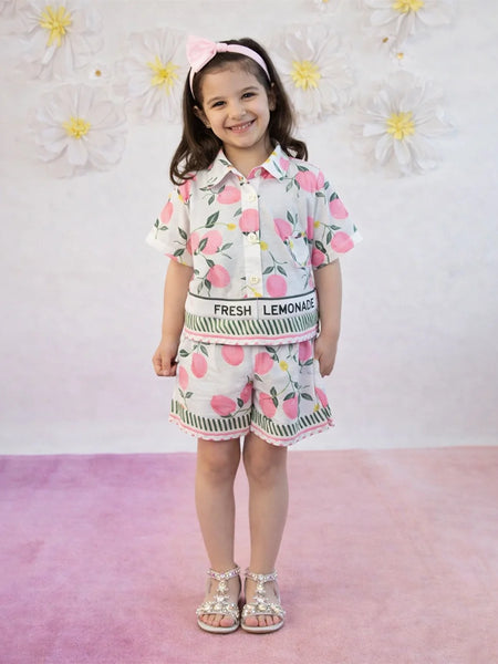 Child wearing a floral outfit with 'Fresh Lemonade' text against a floral background