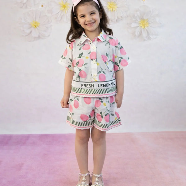 Child wearing a floral outfit with 'Fresh Lemonade' text against a floral background