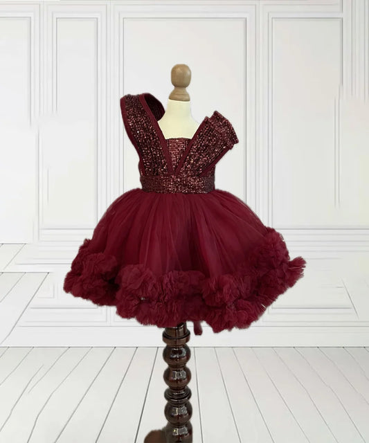 It’s the latest birthday frock for girls with a back zip closure. It features a designer yoke curated from sequin fabric, a detachable tail and frill detailing on the frock.