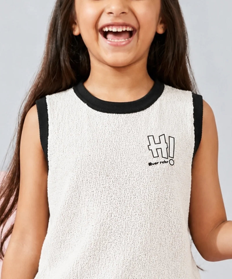 Child wearing a white sleeveless shirt with black trim and 'HI!' print on a gray background