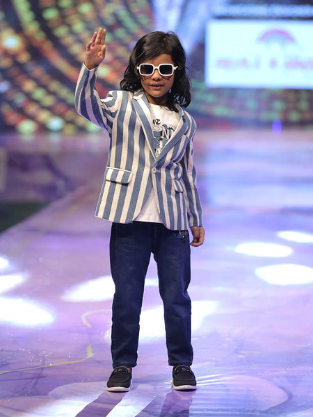 A boy wearing a striped blazer and sunglasses.