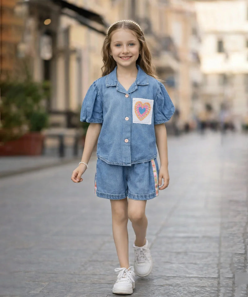 Young girl in a denim outfit walking on a street.