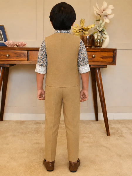 Person wearing a beige vest and pants set in a room with wooden furniture and decorative items.