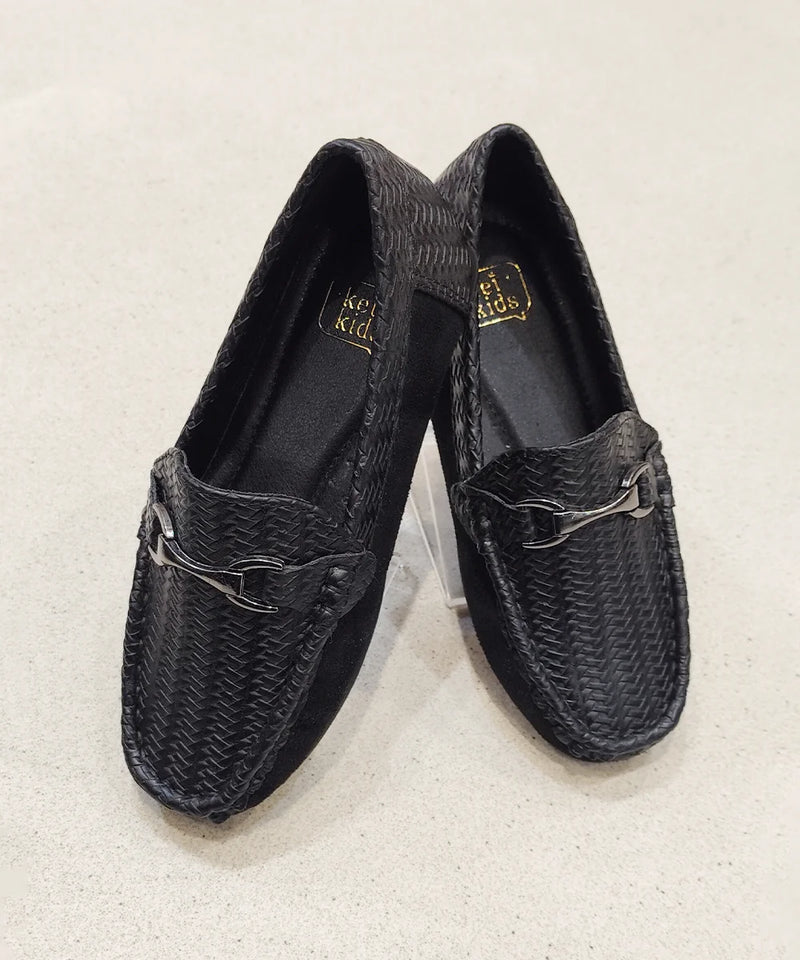 Pair of black woven loafers on a light beige background