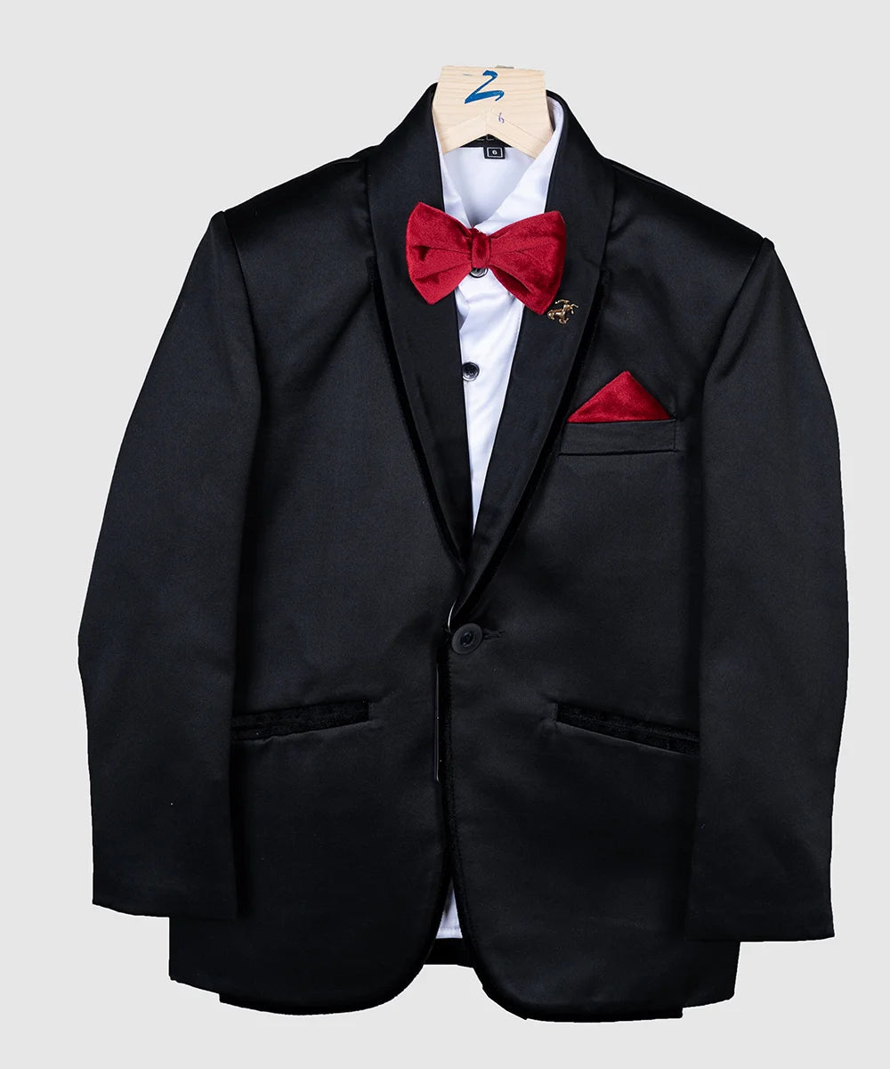This stylish coat for boys is rendered in full black colour and comes with matching pants, a white shirt, a red bow and a red pocket square. It features a nice small broach, a bow and a pocket square created from a velvet fabric.