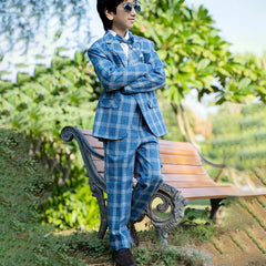 A classic blue checked suit set that comes with a white full-sleeve shirt, checked coat, matching pants and bow. It features one-button fastening, a broach-on lapel collar and pockets on both sides.