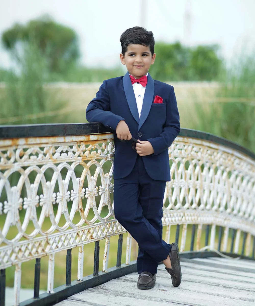 An elegant Suit set that comes with a blue coat, white shirt and blue pants perfect for every formal occasion. This top-line quality suit set is paired with a beautiful red coloured bow and a pocket square.