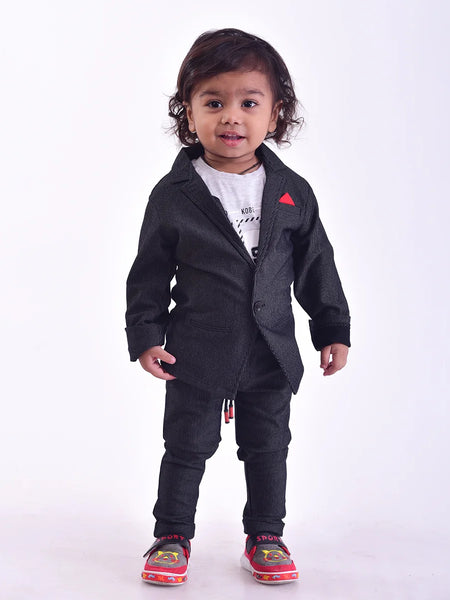 This black Colored boy's wedding outfit comes with trousers, a blazer a white round neck and a half-sleeved t-shirt