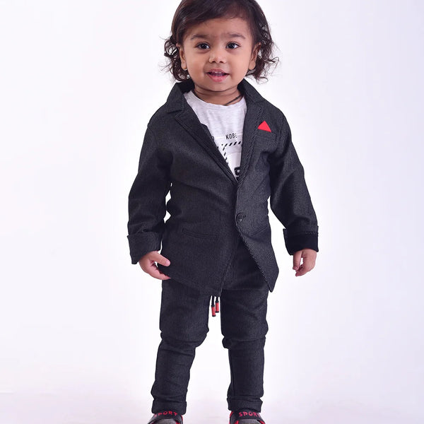 This black Colored boy's wedding outfit comes with trousers, a blazer a white round neck and a half-sleeved t-shirt