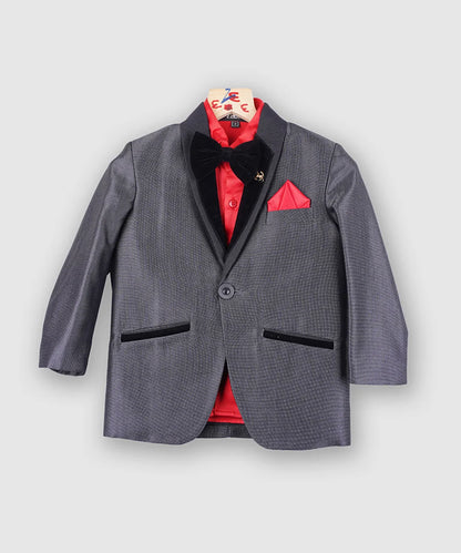 The Steel grey coat suit is paired with a beautiful red satin shirt, a bow and straight trousers. It features a self-textured blazer as well as a bow and small collar created from a velvet fabric. 