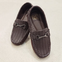 Pair of brown woven loafers with a brand label on a light beige background
