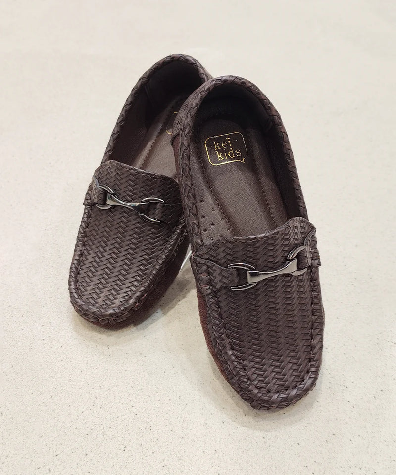 Pair of brown woven loafers with a brand label on a light beige background