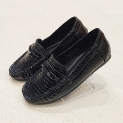 Pair of black loafers on a light gray background
