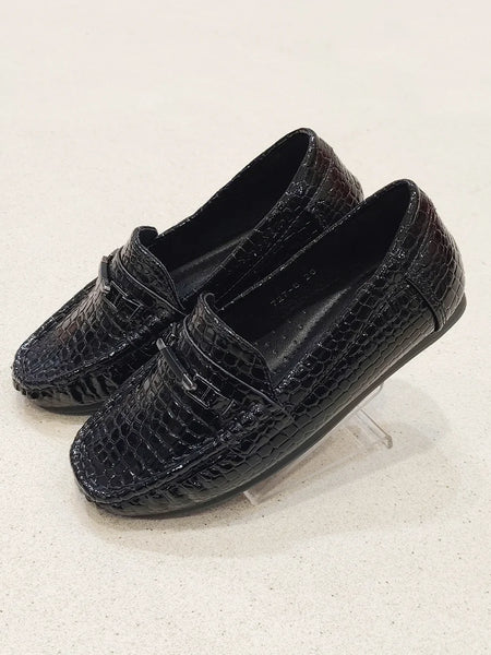 Pair of black loafers on a light gray background