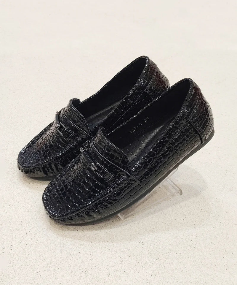 Pair of black loafers on a light gray background