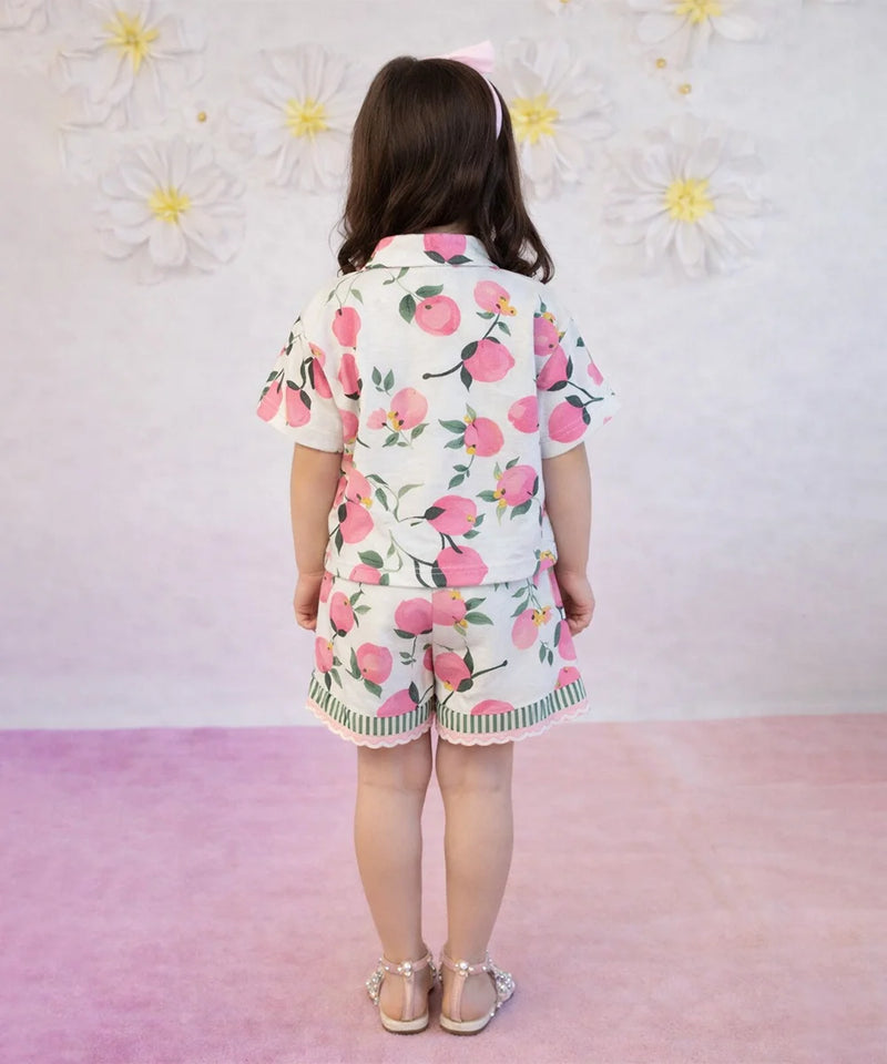 Child wearing a floral outfit with a pink background