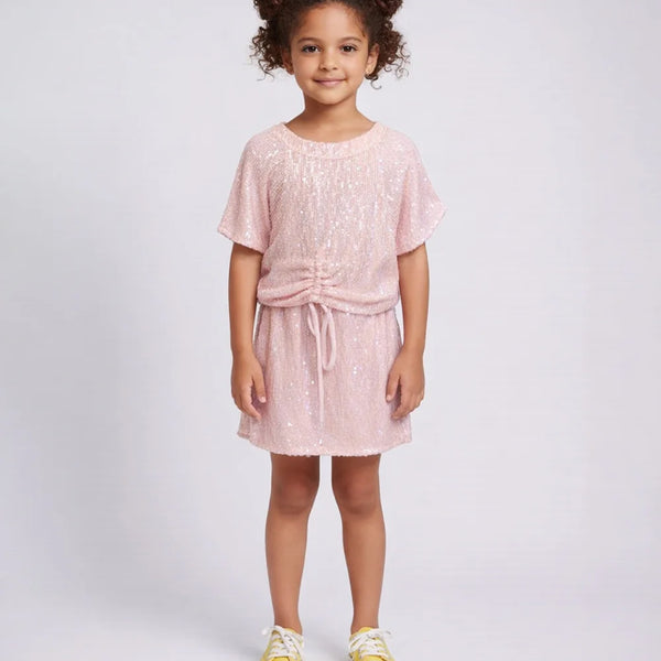 Young girl wearing a pink dress with a white background