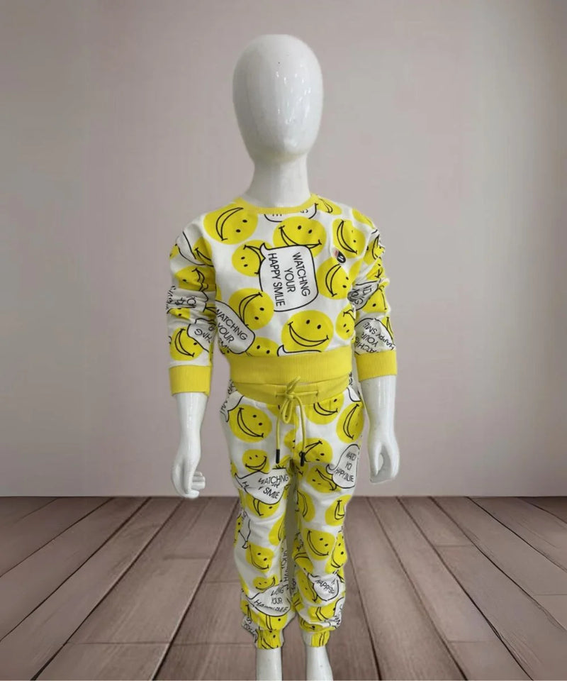 It is a yellow-coloured co-ord set for baby girls. It features a smiley print and the bottom comes with tie-string detailing.