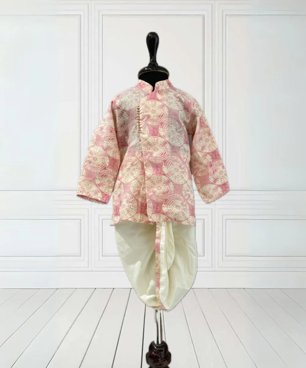 It is a pink Colored printed kurta teamed up with a matching dhoti that comes with an elasticated waist and tie-string belt. It's the best boy's designer kurta-pyjama set.