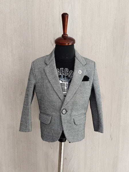 Gray blazer on a mannequin against a light wooden background