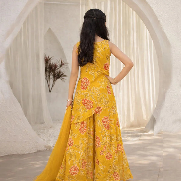 Woman wearing a yellow floral dress in a decorative setting