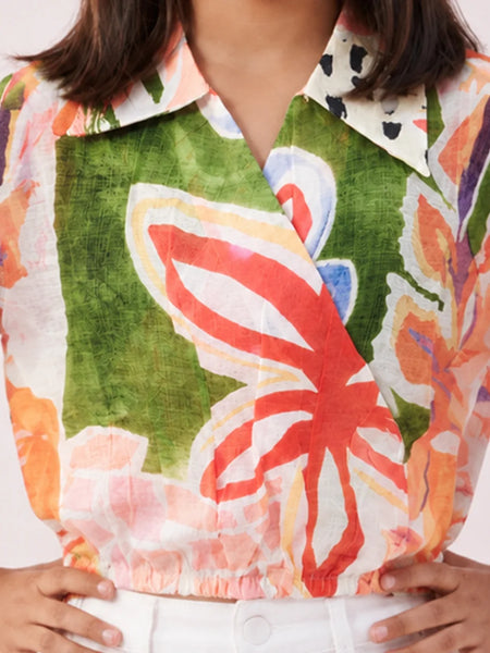 Close-up of a colorful floral shirt with a green background