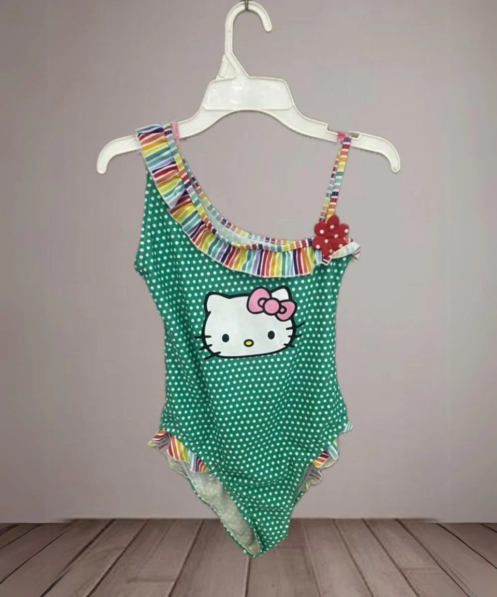 It's a cartoon-printed polka-dotted swimsuit for girls. It features frill detailing and cute floral detailing on the dress.