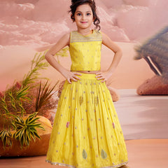 girls wearing yellow embroider lehenga choli in smiley face.